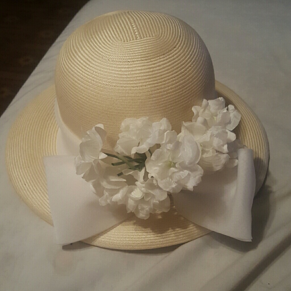 White hat with white bow ribbon and white flowers